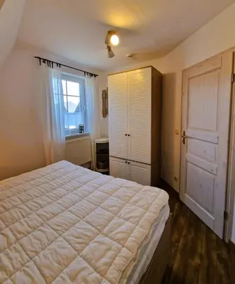 Ein Bett oder Betten in einem Zimmer der Unterkunft Wiesenstr. FeWo Kirr