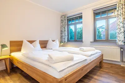 Ein Bett oder Betten in einem Zimmer der Unterkunft Ferienhaussiedlung Strandperlen Buchenhof 2a (Typ VIII)