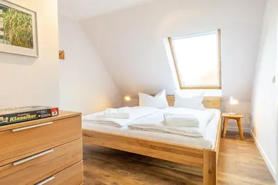 Ein Bett oder Betten in einem Zimmer der Unterkunft Ferienhaussiedlung Strandperlen Buchenhof 2a (Typ VIII)
