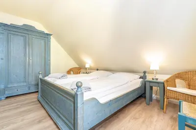 Ein Bett oder Betten in einem Zimmer der Unterkunft Ferienhaussiedlung Strandperlen Küstenhof 1a (Typ IV)