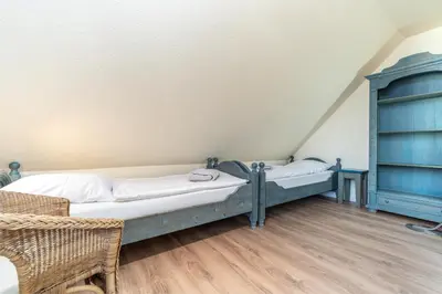 Ein Bett oder Betten in einem Zimmer der Unterkunft Ferienhaussiedlung Strandperlen Küstenhof 1a (Typ IV)
