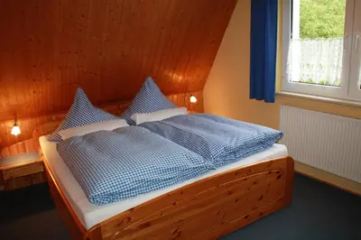 Ein Bett oder Betten in einem Zimmer der Unterkunft Ferienhaus Eulennest - Ulenhoef