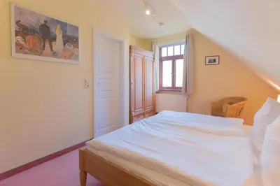 Ein Bett oder Betten in einem Zimmer der Unterkunft Ferienhaussiedlung Strandperlen Buchenhof 4d (Typ IV)