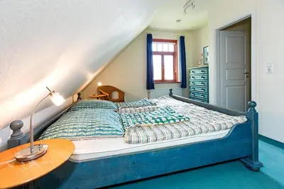 Ein Bett oder Betten in einem Zimmer der Unterkunft Ferienhaussiedlung Strandperlen Buchenhof 5a (Typ IV)