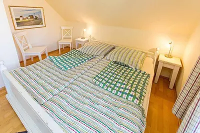 Ein Bett oder Betten in einem Zimmer der Unterkunft Ferienhaussiedlung Strandperlen Weidenhof 6a (Typ VII)