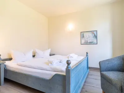 Ein Bett oder Betten in einem Zimmer der Unterkunft Ferienhaussiedlung Strandperlen Weidenhof 6b (Typ IX)