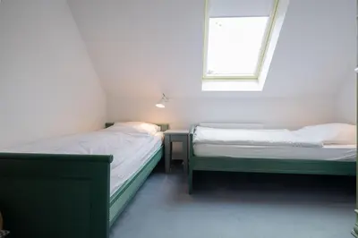 Ein Bett oder Betten in einem Zimmer der Unterkunft Ferienhaussiedlung Strandperlen Weidenhof 9a (Typ VII)
