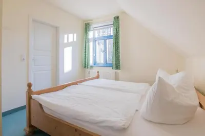 Ein Bett oder Betten in einem Zimmer der Unterkunft Ferienhaussiedlung Strandperlen Weidenhof 9b (Typ IX)