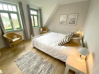Ein Bett oder Betten in einem Zimmer der Unterkunft Ferienhaussiedlung Strandperlen Weidenhof 3b (Typ VI)