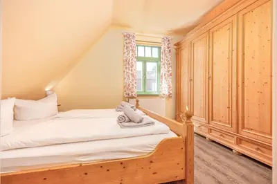 Ein Bett oder Betten in einem Zimmer der Unterkunft Ferienhaussiedlung Strandperlen Weidenhof 3c (Typ II)