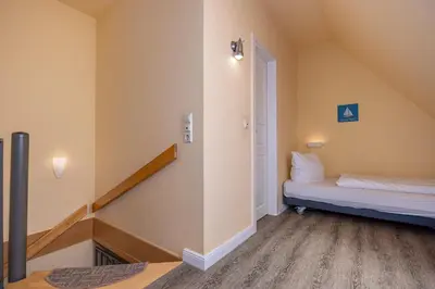 Ein Bett oder Betten in einem Zimmer der Unterkunft Ferienhaussiedlung Strandperlen Weidenhof 3c (Typ II)
