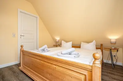 Ein Bett oder Betten in einem Zimmer der Unterkunft Ferienhaussiedlung Strandperlen Weidenhof 3c (Typ II)