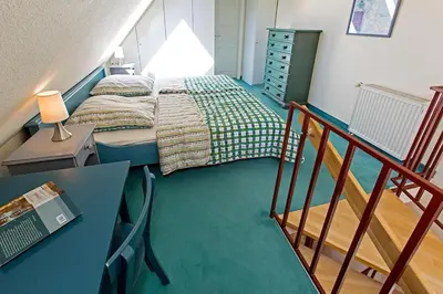 Ein Bett oder Betten in einem Zimmer der Unterkunft Ferienhaussiedlung Strandperlen Sanddornhof 3d (Typ I)