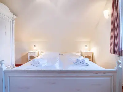 Ein Bett oder Betten in einem Zimmer der Unterkunft Ferienhaussiedlung Strandperlen Sanddornhof 4a (Typ IX)