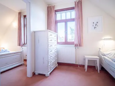Ein Bett oder Betten in einem Zimmer der Unterkunft Ferienhaussiedlung Strandperlen Sanddornhof 4a (Typ IX)