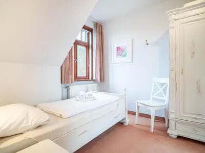 Ein Bett oder Betten in einem Zimmer der Unterkunft Ferienhaussiedlung Strandperlen Sanddornhof 4a (Typ IX)