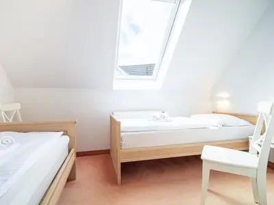 Ein Bett oder Betten in einem Zimmer der Unterkunft Ferienhaussiedlung Strandperlen Sanddornhof 4a (Typ IX)