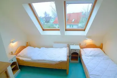 Ein Bett oder Betten in einem Zimmer der Unterkunft Ferienhaussiedlung Strandperlen Sanddornhof 8b (Typ IX)