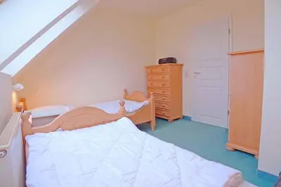 Ein Bett oder Betten in einem Zimmer der Unterkunft Ferienhaussiedlung Strandperlen Sanddornhof 8b (Typ IX)