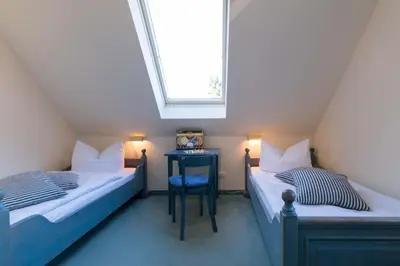Ein Bett oder Betten in einem Zimmer der Unterkunft Ferienhaussiedlung Strandperlen Küstenhof 4a (Typ IX)