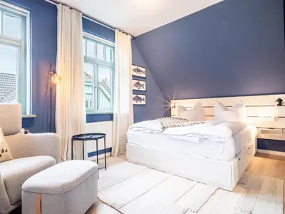 Ein Bett oder Betten in einem Zimmer der Unterkunft Ferienhaussiedlung Strandperlen Küstenhof 4b (Typ IX)