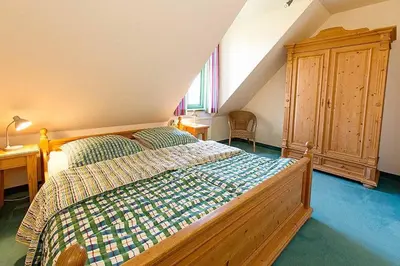 Ein Bett oder Betten in einem Zimmer der Unterkunft Ferienhaussiedlung Strandperlen Küstenhof 1b (Typ V)