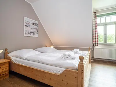 Ein Bett oder Betten in einem Zimmer der Unterkunft Ferienhaussiedlung Strandperlen Küstenhof 2b (Typ V)