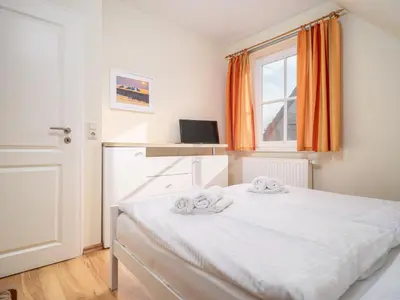 Ein Bett oder Betten in einem Zimmer der Unterkunft Haus MEERESRAUSCHEN Whg. MR-2
