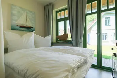Ein Bett oder Betten in einem Zimmer der Unterkunft Ferienhaussiedlung Strandperlen Buchenhof 6a (Typ III)