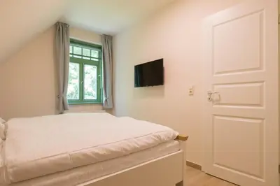 Ein Bett oder Betten in einem Zimmer der Unterkunft Ferienhaussiedlung Strandperlen Buchenhof 6a (Typ III)