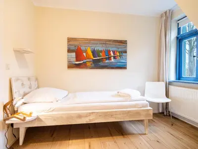 Ein Bett oder Betten in einem Zimmer der Unterkunft Ferienhaussiedlung Strandperlen Sanddornhof 6b (Typ VII)