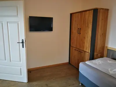 Ein Bett oder Betten in einem Zimmer der Unterkunft Boddenkutter