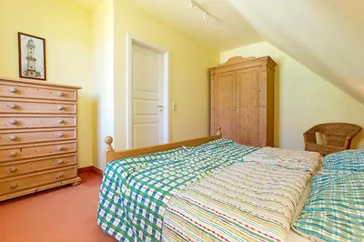 Ein Bett oder Betten in einem Zimmer der Unterkunft Ferienhaussiedlung Strandperlen Buchenhof 4a (Typ IV)