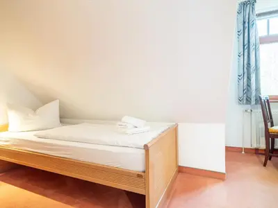 Ein Bett oder Betten in einem Zimmer der Unterkunft Ferienhaussiedlung Strandperlen Buchenhof 4b (Typ V)