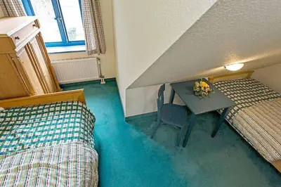 Ein Bett oder Betten in einem Zimmer der Unterkunft Ferienhaussiedlung Strandperlen Weidenhof 8c (Typ V)