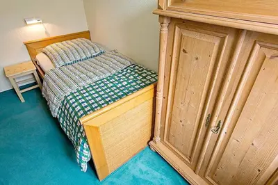 Ein Bett oder Betten in einem Zimmer der Unterkunft Ferienhaussiedlung Strandperlen Weidenhof 8c (Typ V)