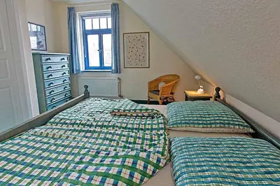 Ein Bett oder Betten in einem Zimmer der Unterkunft Ferienhaussiedlung Strandperlen Weidenhof 8d (Typ IV)