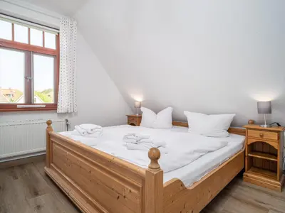 Ein Bett oder Betten in einem Zimmer der Unterkunft Ferienhaussiedlung Strandperlen Weidenhof 4a (Typ III)