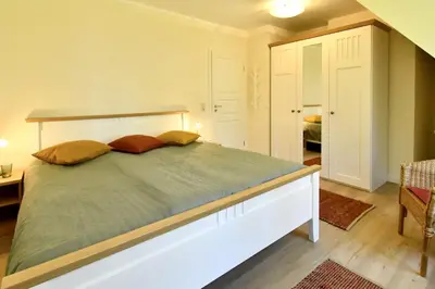 Ein Bett oder Betten in einem Zimmer der Unterkunft Ferienhaussiedlung Strandperlen Sanddornhof 7b (Typ VI)