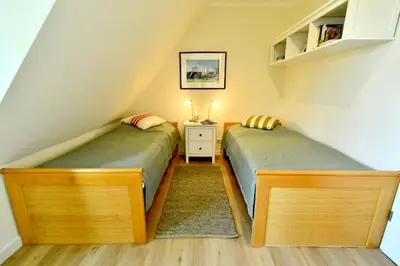 Ein Bett oder Betten in einem Zimmer der Unterkunft Ferienhaussiedlung Strandperlen Sanddornhof 7b (Typ VI)