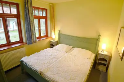 Ein Bett oder Betten in einem Zimmer der Unterkunft Ferienhaussiedlung Strandperlen Sanddornhof 2a (Typ VIII)