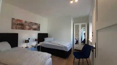 Ein Bett oder Betten in einem Zimmer der Unterkunft FH Magnolia fuer 12 Pers. mit Terrasse + Dachterasse