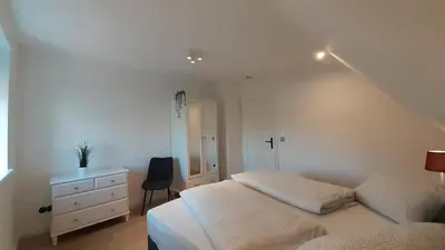 Ein Bett oder Betten in einem Zimmer der Unterkunft FH Magnolia fuer 12 Pers. mit Terrasse + Dachterasse