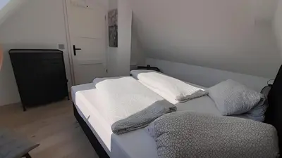 Ein Bett oder Betten in einem Zimmer der Unterkunft FH Magnolia fuer 12 Pers. mit Terrasse + Dachterasse