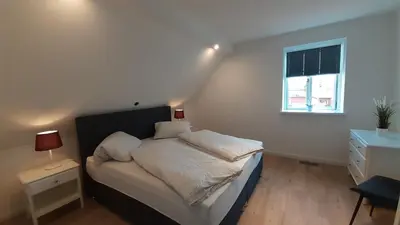 Ein Bett oder Betten in einem Zimmer der Unterkunft FH Magnolia fuer 12 Pers. mit Terrasse + Dachterasse
