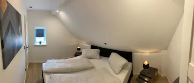 Ein Bett oder Betten in einem Zimmer der Unterkunft FH Magnolia fuer 12 Pers. mit Terrasse + Dachterasse