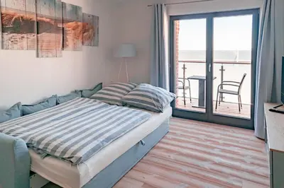 Ein Bett oder Betten in einem Zimmer der Unterkunft Boddenkieker