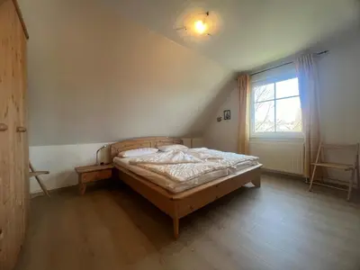 Ein Bett oder Betten in einem Zimmer der Unterkunft to Hus