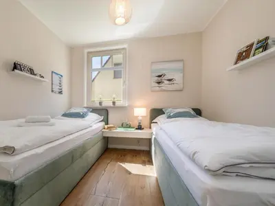 Ein Bett oder Betten in einem Zimmer der Unterkunft Meerliebe