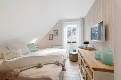Ein Bett oder Betten in einem Zimmer der Unterkunft Mondmuschel